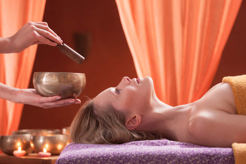 une-femme-qui-relaxe-avec-le-son-d-un-bol-tibetain.jpg